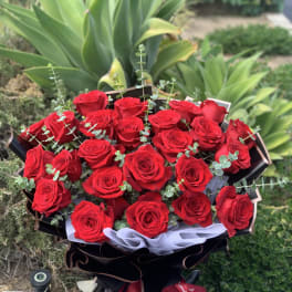 Bouquet of red roses with eucalyptus in black wrapping