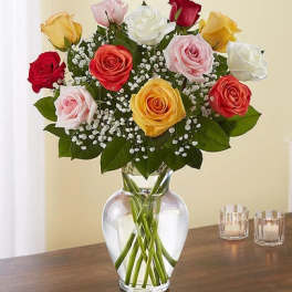 Bouquet of multicolored roses in a clear glass vase