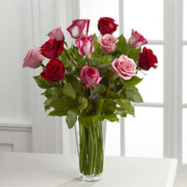 Bouquet of red and pink roses in a clear glass vase