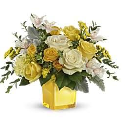 Yellow and white rose bouquet in a square glass vase