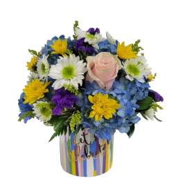 Colorful bouquet with a pink rose in a striped container