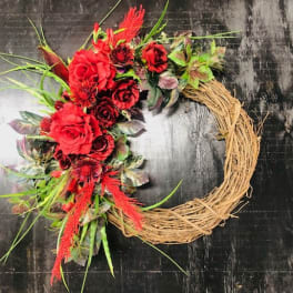 Red floral wreath on a straw ring base