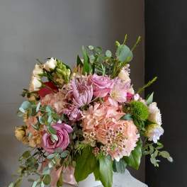 Pink and cream mixed bouquet in a white vase