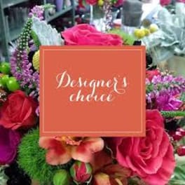 Colorful bouquet with pink roses and purple flowers behind a designer's choice sign