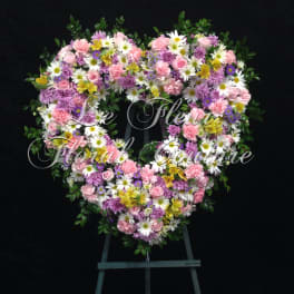 Heart-shaped floral wreath with pink, white, purple, and yellow blooms