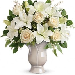 White lilies and cream roses arranged in a vase