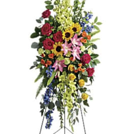 Tall standing floral spray with roses, lilies, sunflowers, and mixed blooms