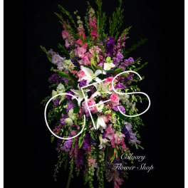Tall standing floral spray with pink, purple, and white flowers
