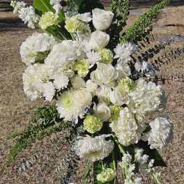 Large white floral standing spray with roses, hydrangeas, and chrysanthemums