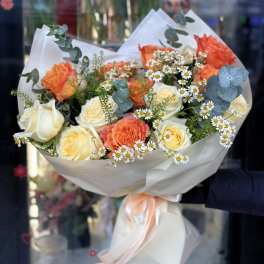 Bouquet of orange and white roses with small white daisies