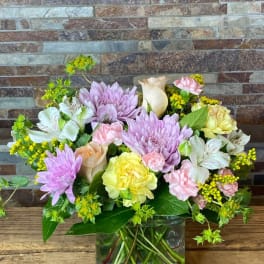 Mixed pastel bouquet in a square glass vase