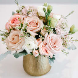 Blush and white rose bouquet in a gold vase