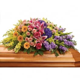 Colorful floral spray on a wooden casket