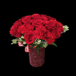 Red roses and carnations in a glittery red vase