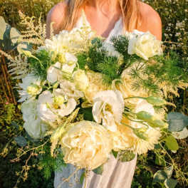 Bride holding a large white and cream bouquet