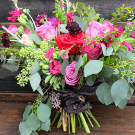Bouquet of pink and red roses with eucalyptus and dark accent flowers