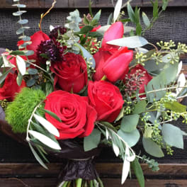 Bouquet of red roses with eucalyptus and dark wrapping