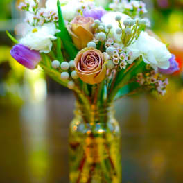 Mixed bouquet of roses and tulips in a glass vase