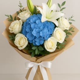 Blue hydrangea bouquet with white roses and a white lily