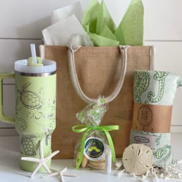 Gift set with a tumbler, tote bag, wrapped blanket, cookies, and starfish decor