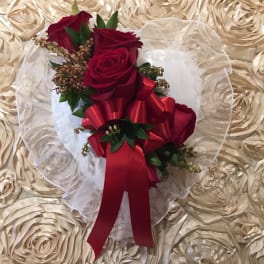 Red rose bouquet with a large red ribbon on white tulle