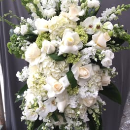 Large white floral spray with roses, orchids, and hydrangeas