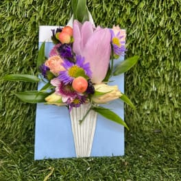 Small bouquet with pink tulip and purple flowers in a white wrap