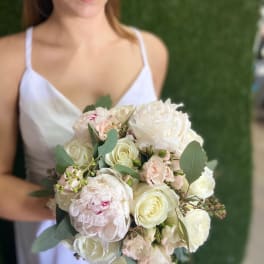 Bride holding a pale pink and white bouquet with eucalyptus