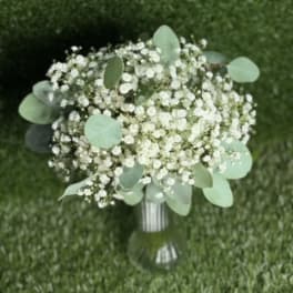 White baby's breath bouquet with eucalyptus in a glass vase