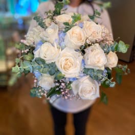 Bouquet of white roses with blue accents and eucalyptus