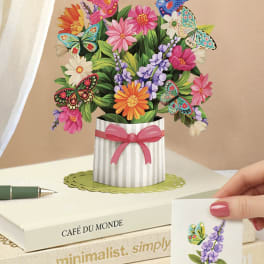 Pop-up bouquet card with colorful flowers and butterflies in a striped vase