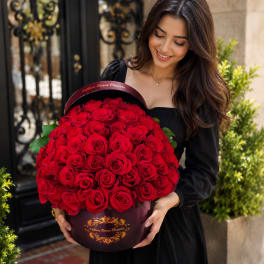RED ROSES IN A BLACK ROUND BOX