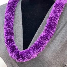 Plush purple lei necklace displayed on a black mannequin torso
