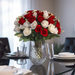 Red and white roses arranged in a clear glass vase