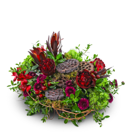 Mixed floral arrangement with red blooms and lotus pods