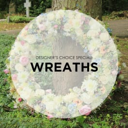 Large floral wreath with white and pastel flowers around a tree trunk