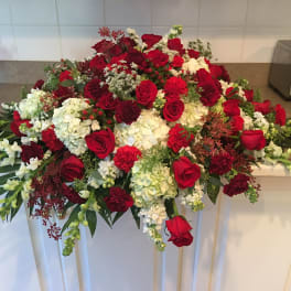 Large red and white floral arrangement with roses and carnations