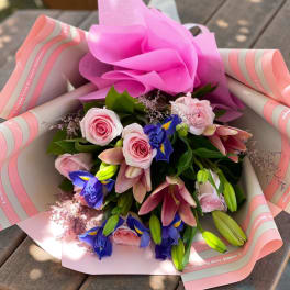 Pink and blue mixed bouquet wrapped in pink paper