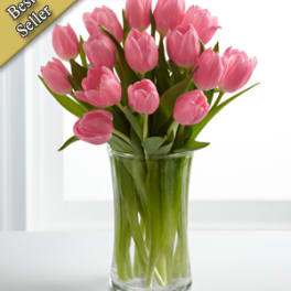 Pink tulips arranged in a clear glass vase