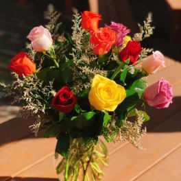 Bouquet of multicolored roses in a clear glass vase