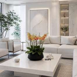 Potted orchid arrangement with yellow and peach blooms on a coffee table