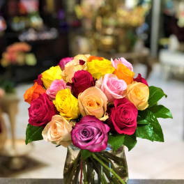 Bouquet of multicolored roses in a clear glass vase