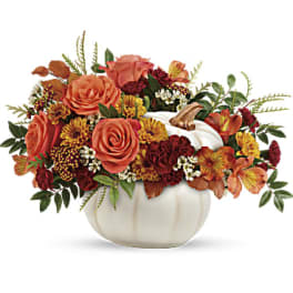 Autumn floral arrangement in a white pumpkin vase