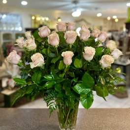 Bouquet of pale pink roses in a clear glass vase