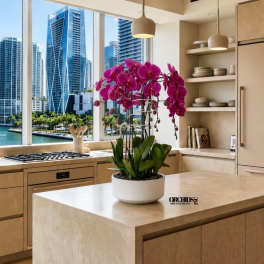 Potted magenta orchids in a white planter on a kitchen island