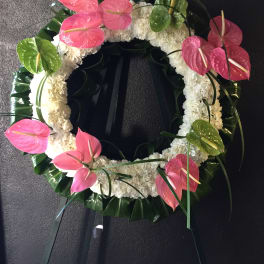 Circle of white mums with pink & green anthurium with Ti leaves surround wreath - F30014