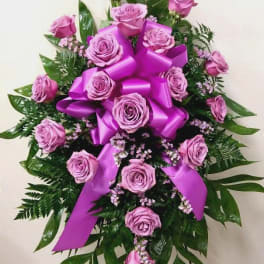 Pink rose spray with a large purple ribbon bow