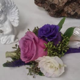 Boutonniere with pink, purple, and white roses