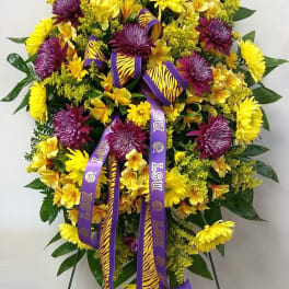 Large yellow and purple floral standing spray with LSU ribbons
