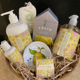 Basket of lemon verbena bath and hand soap products with floral labels